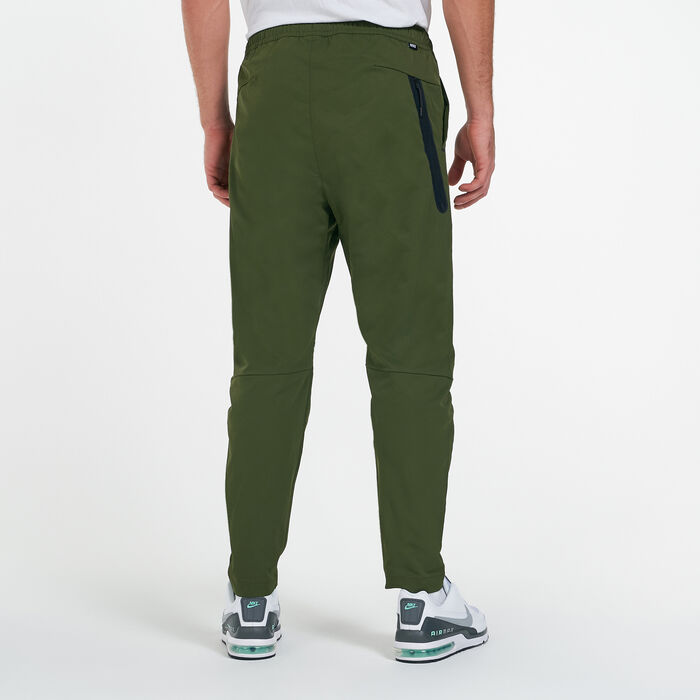 Nike Men's Sportswear Tech Essentials Unlined Commuter Pants Green Nike Men's Sportswear Tech Essentials Unlined Commuter Pants Green image number 1