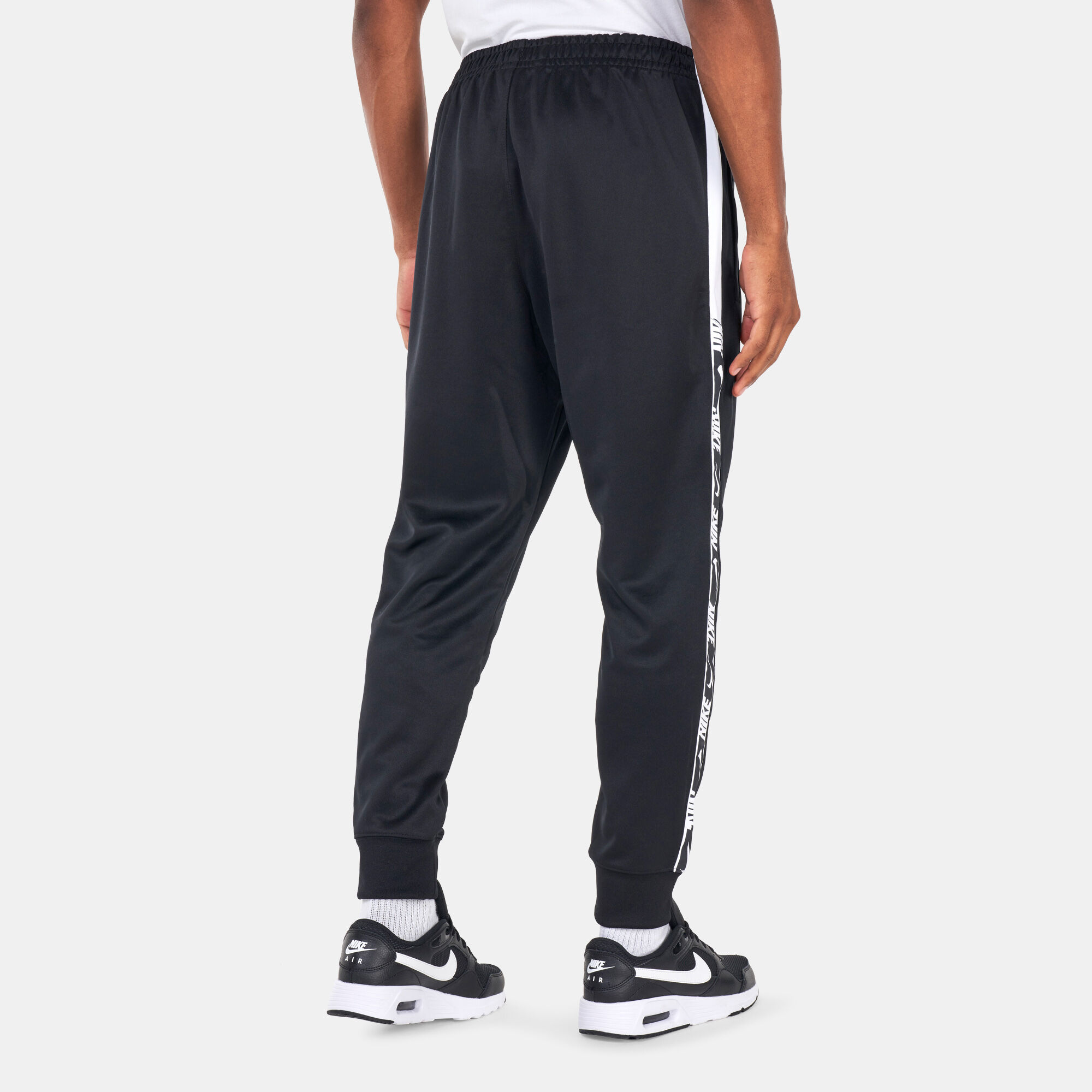 Nike swoosh tape track pants outlet