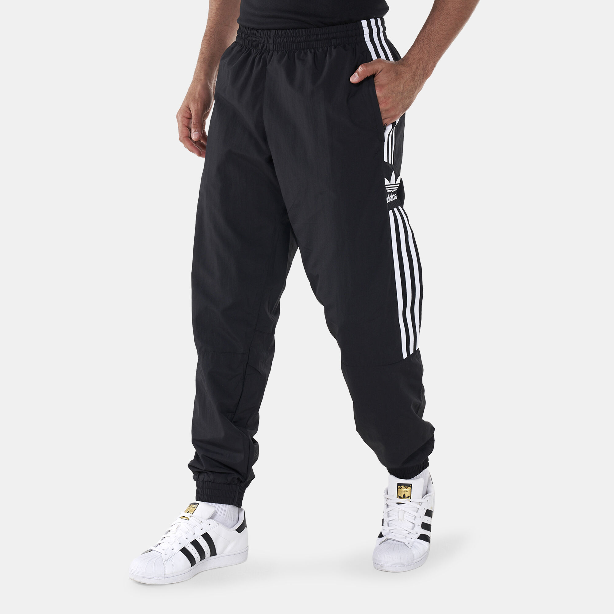 Adidas originals adicolor locked up logo track pants in black clearance