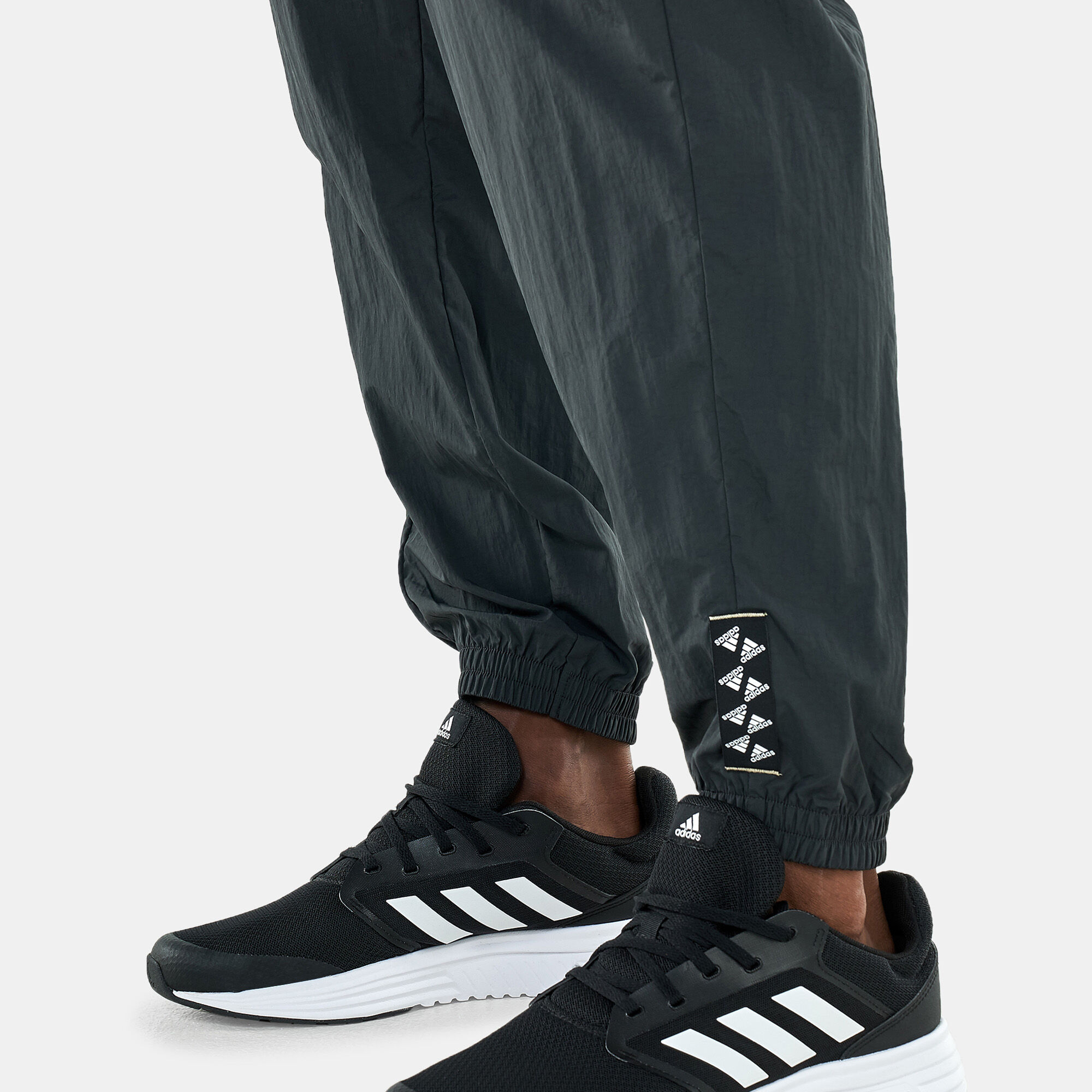 Men s BrandLove Woven Track Pants Black adidas in Qatar SSS